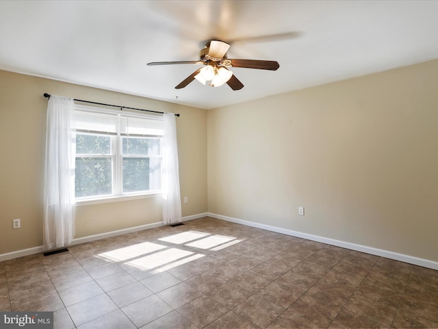 tiled empty room with ceiling fan