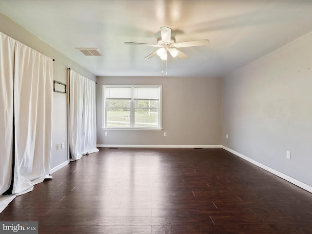 spare room with ceiling fan and dark hardwood / wood-style flooring