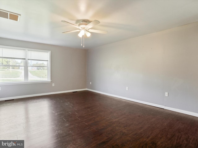 unfurnished room featuring ceiling fan and dark hardwood / wood-style floors