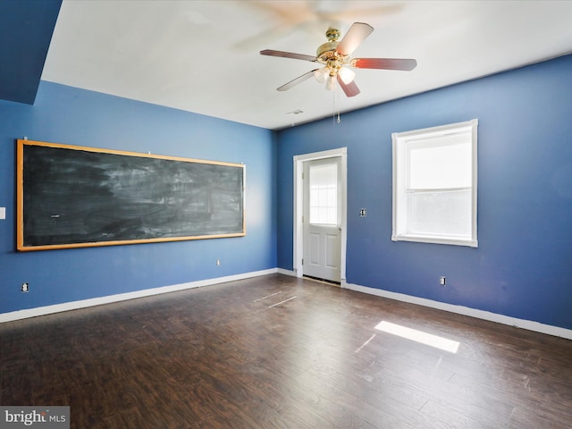 empty room featuring ceiling fan and dark hardwood / wood-style flooring