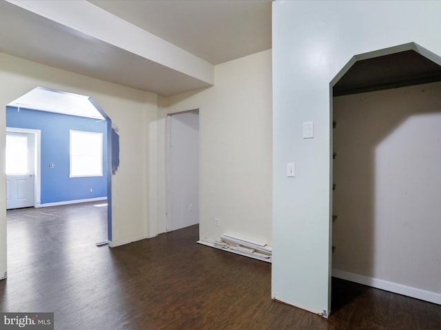 bonus room with dark wood-type flooring