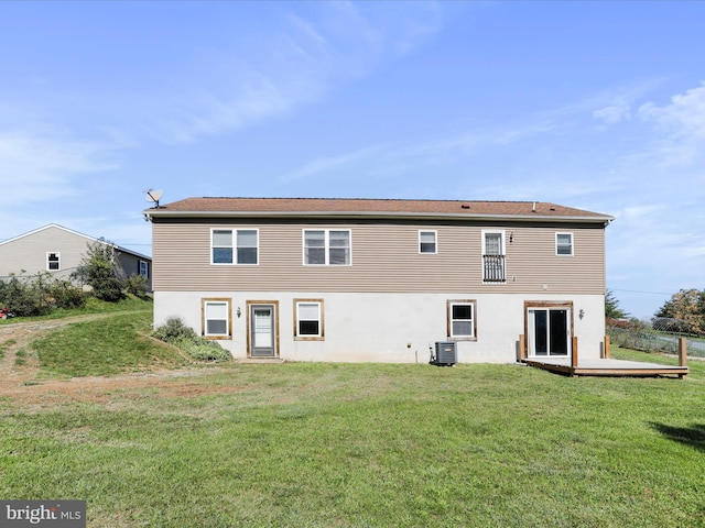 rear view of house featuring cooling unit, a yard, and a wooden deck