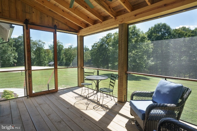 unfurnished sunroom featuring lofted ceiling with beams and wooden ceiling