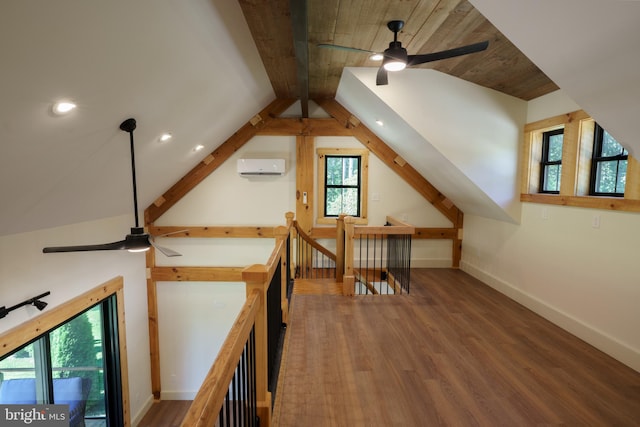 bonus room featuring vaulted ceiling with beams, hardwood / wood-style flooring, and a wall unit AC