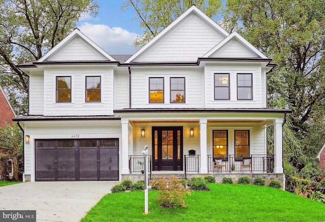 view of front facade with a front yard, a garage, and a porch