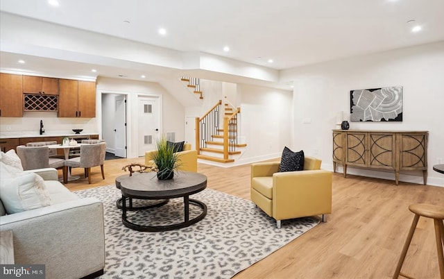 living room featuring light wood-type flooring and sink