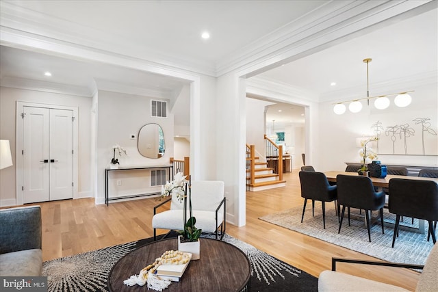 living room with ornamental molding and hardwood / wood-style floors