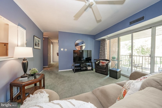 carpeted living room with ceiling fan