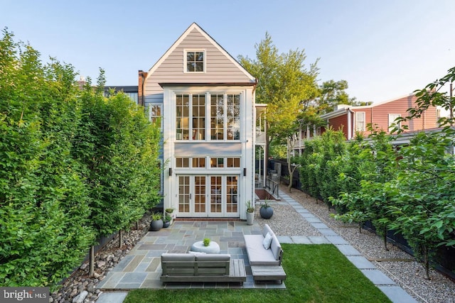 back of property featuring french doors and a patio area