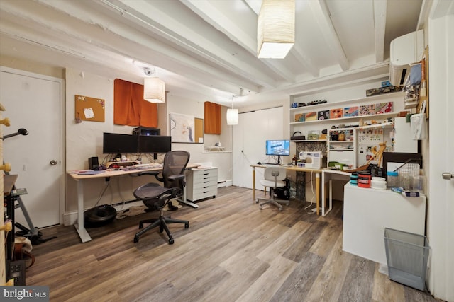 office featuring beamed ceiling and light wood-type flooring