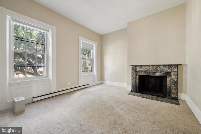 unfurnished living room featuring a premium fireplace, light colored carpet, and baseboard heating