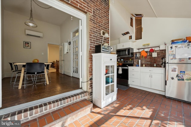 kitchen with stainless steel appliances, high vaulted ceiling, and white cabinetry