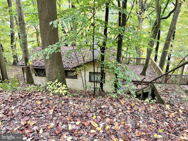 view of home's exterior with a wooden deck