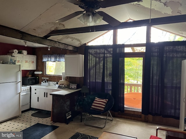 kitchen featuring ceiling fan, vaulted ceiling with beams, white appliances, and white cabinetry