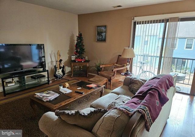 living room with hardwood / wood-style flooring and a healthy amount of sunlight