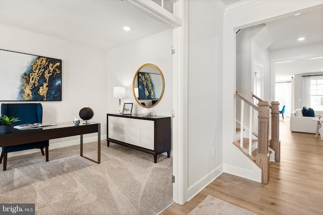 office space featuring crown molding and light hardwood / wood-style flooring