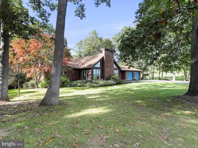 view of side of property with a yard