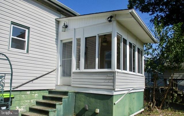 view of side of property featuring a sunroom