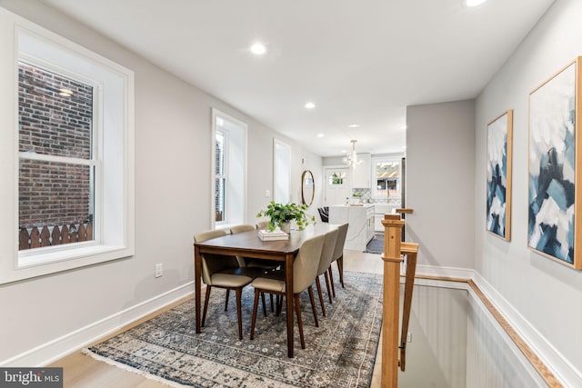 dining area featuring hardwood / wood-style floors and a chandelier