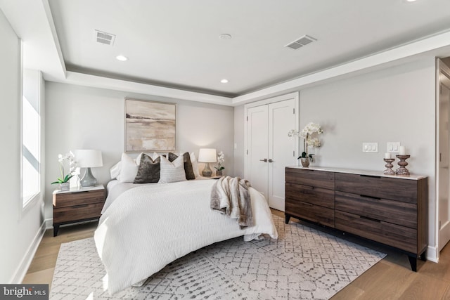 bedroom featuring light hardwood / wood-style flooring and a closet