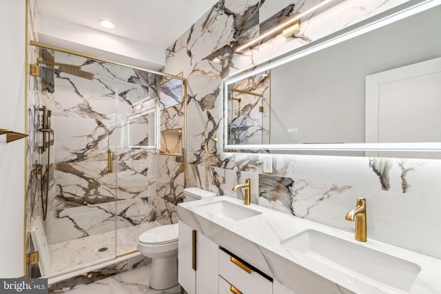 bathroom featuring vanity, toilet, tasteful backsplash, and a shower with door