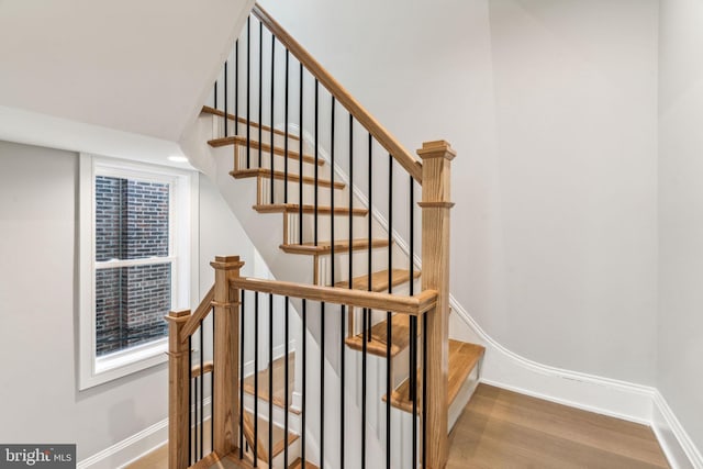 stairs featuring hardwood / wood-style flooring