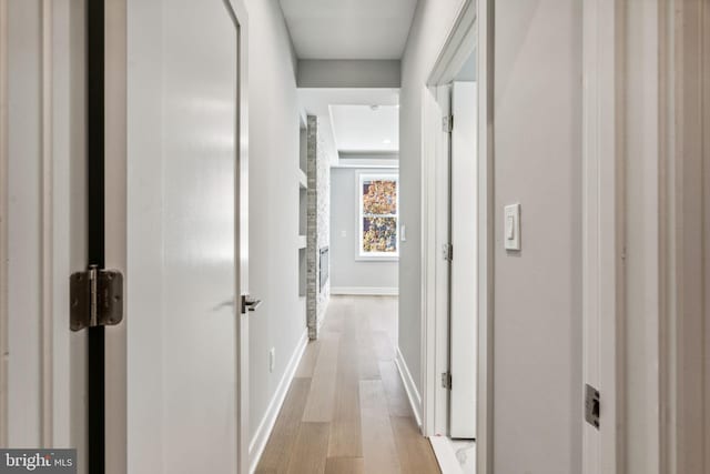 hallway with light hardwood / wood-style flooring