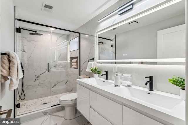 bathroom with vanity, an enclosed shower, and toilet