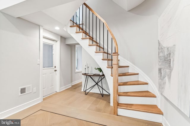 stairway with hardwood / wood-style flooring