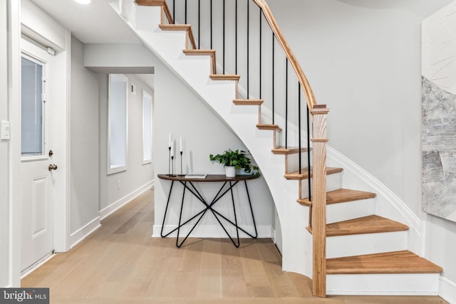 stairway with hardwood / wood-style floors