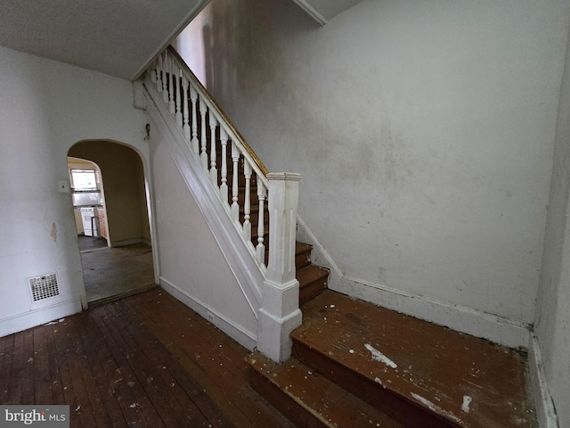 stairway featuring hardwood / wood-style flooring