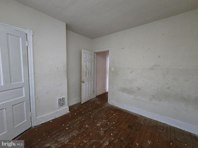 unfurnished room with dark hardwood / wood-style flooring