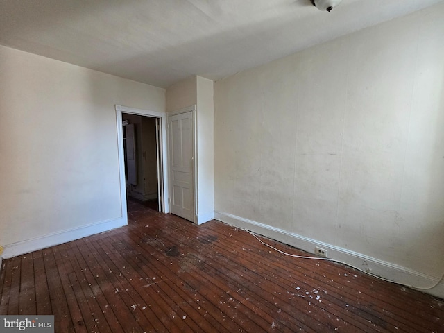 spare room featuring dark hardwood / wood-style flooring