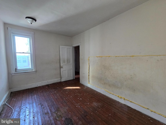 spare room featuring dark hardwood / wood-style flooring