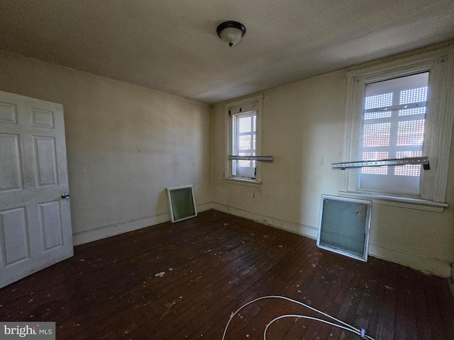 spare room featuring dark wood-type flooring