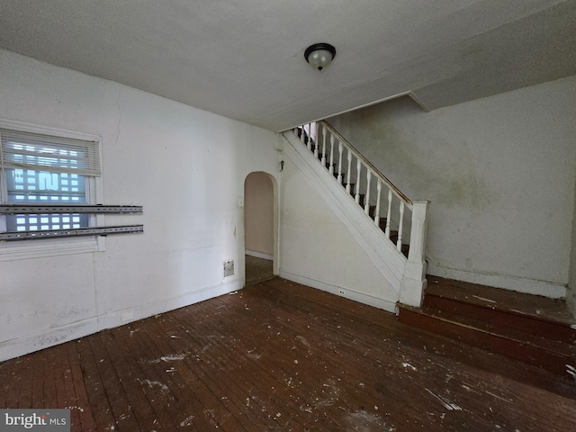 unfurnished living room with dark hardwood / wood-style floors