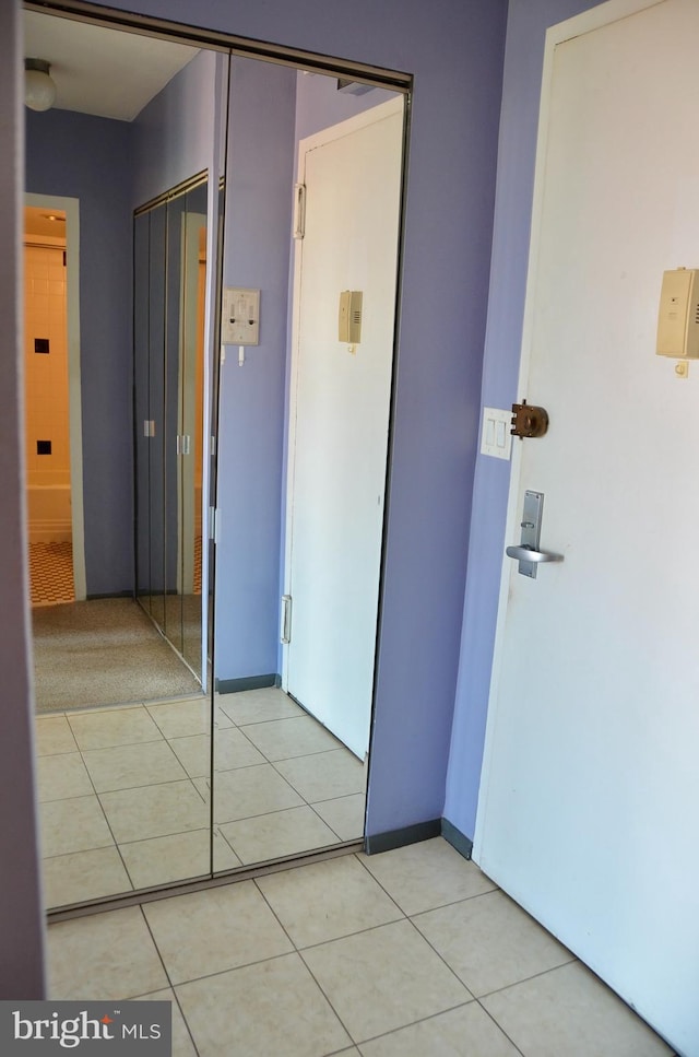 hall with light tile patterned floors