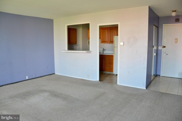 unfurnished living room featuring light colored carpet