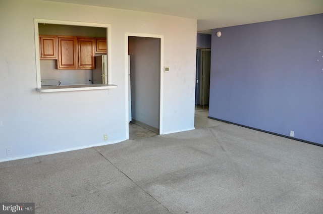 unfurnished living room featuring light carpet