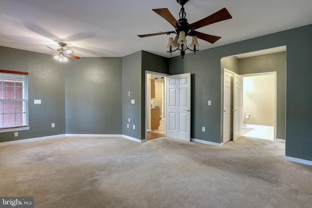 unfurnished bedroom with light carpet and connected bathroom