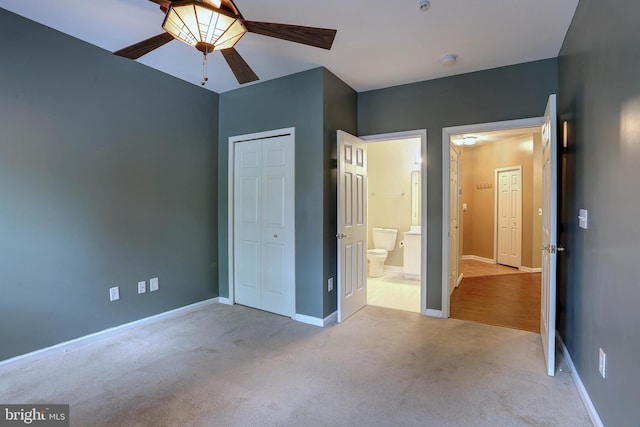 unfurnished bedroom with a closet, ceiling fan, and light colored carpet