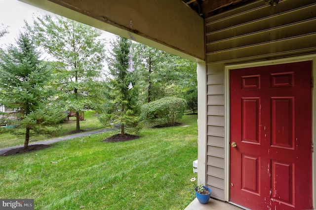 doorway to property with a yard