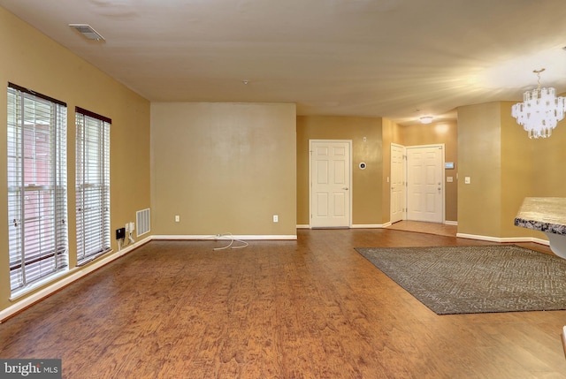 interior space featuring hardwood / wood-style flooring and a notable chandelier