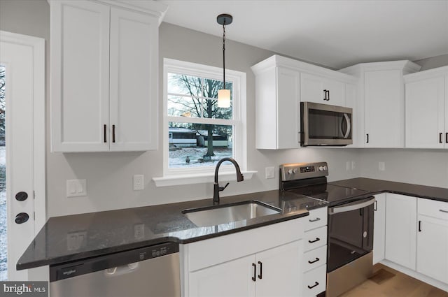 kitchen with white cabinets, appliances with stainless steel finishes, and sink