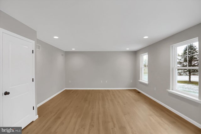 empty room with light hardwood / wood-style flooring