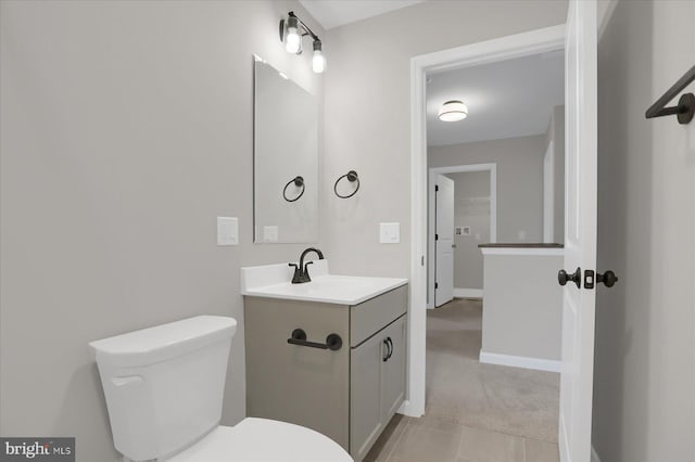 bathroom with tile patterned floors, vanity, and toilet