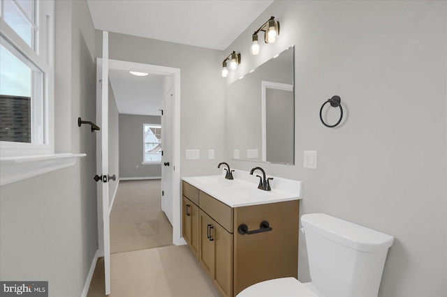 bathroom with tile patterned flooring, vanity, and toilet