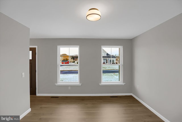 unfurnished room featuring hardwood / wood-style floors