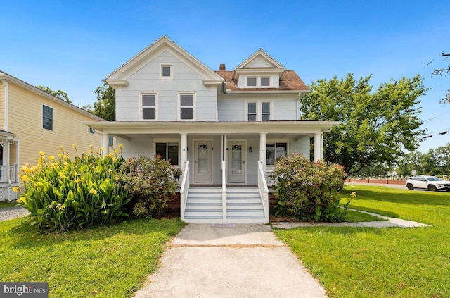 view of front of home with a front yard and a porch