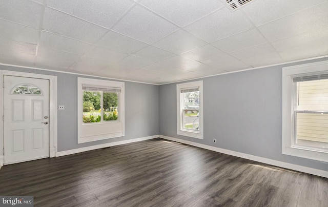 foyer with a drop ceiling and dark wood-type flooring